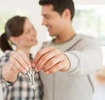 Happy couple holding keys to their new house